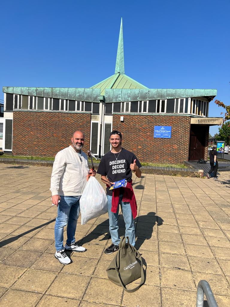 Older man and younger man litter picking in Abbey Wood, London.