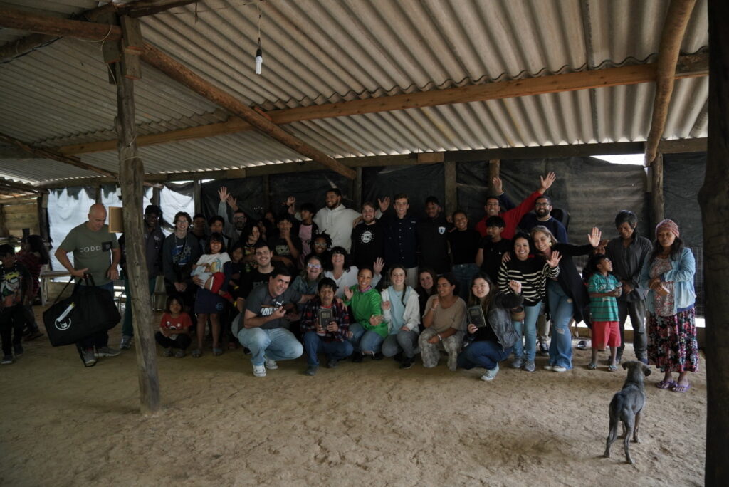 The team with a local tribal chief, pictured in the center, with the provision of God's word clutched in his hands.