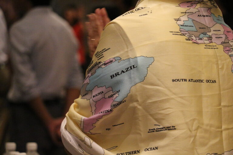 Photo taken at an FATT gathering of woman wearing a global map shawl